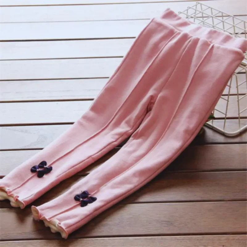 Otroške zimske hlače s pentljo v roza barvi, kosmatene in tople